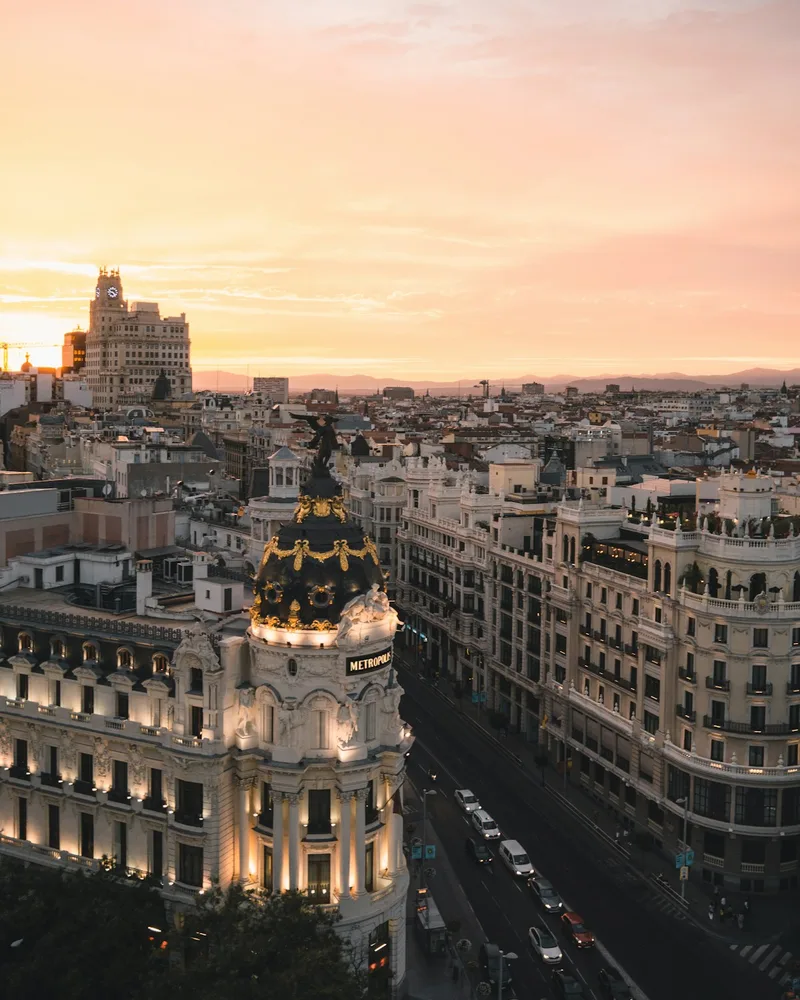 Placeholder: the Metropolis building and Gran Vía in Madrid at dusk